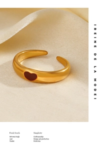 Detail of 18K gold plated heart ring on beige silk with high polish finish