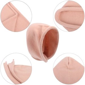 Detail view of pink knitted hat showing rolled edge and soft cashmere-like texture