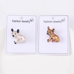 Detailed close-up of cartoon bulldog alloy brooches in silver and gold finish