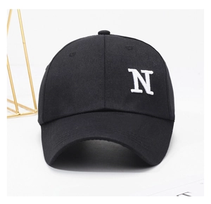 Close-up of white embroidered letter N on a premium black cotton baseball cap
