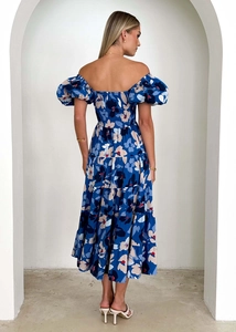 Rear view of off-shoulder blue floral midi dress with puff sleeves and layered skirt