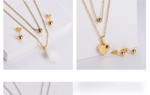 Detail of double-layer chain necklace with heart pendant and matching ball earrings
