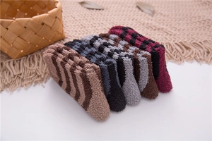 Detail of striped coral fleece socks in assorted colors neatly stacked on woven background