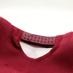 Detail of adjustable double-row plastic snapback closure on burgundy twill hip-hop hat