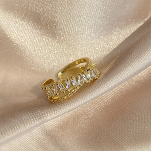 Close-up of double-layer adjustable gold ring with sparkling zircon stones on silk