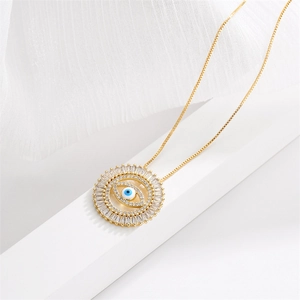 Macro shot of gold devil eye pendant necklace with blue eye and clear zircon stones