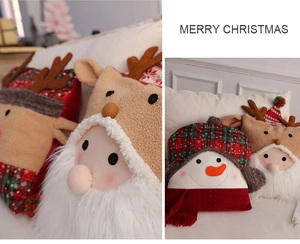 Detail of plush Christmas pillows featuring Santa, reindeer, and snowman in warm colors