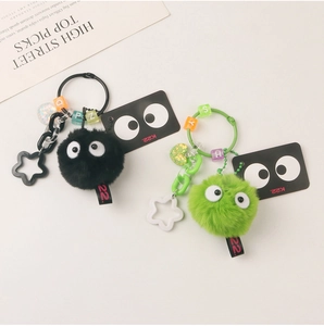 Detail of plush soot sprite keychain with colorful letter beads and star charm