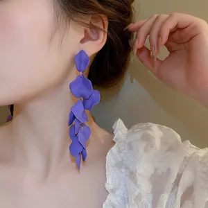 Long purple petal tassel earrings in matte resin finish worn by model in side profile