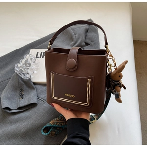 Brown PU leather bucket bag with top handle and printed wide shoulder strap