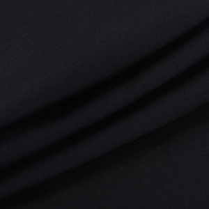 Macro view of fine woven texture on black halter jumpsuit fabric with detailed stitching