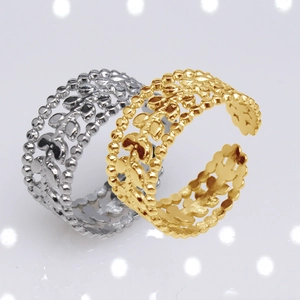 Detail of gold and silver open rings featuring a hollowed-out leaf pattern design