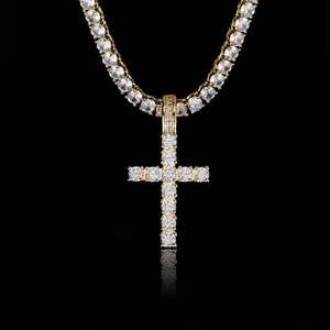 Macro shot of gold plated hip hop cross pendant with pave set clear cubic zirconia crystals