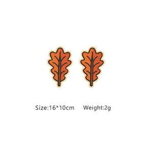 Autumn-themed orange maple leaf stud earrings with detailed black outlines