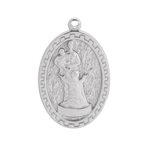 Detailed macro view of an oval silver religious pendant with embossed figure and edge texture