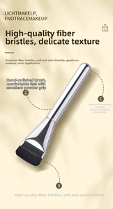Detail of flat foundation brush with premium black fiber bristles and silver metal handle