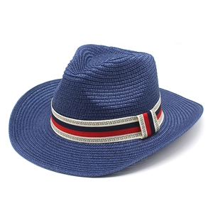 Detail of navy woven straw hat featuring a decorative Greek key pattern ribbon trim