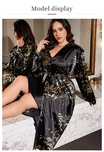 Detail of floral black satin pajama robe showing luxurious fabric texture and patterns