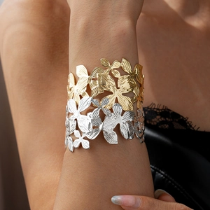 Metallic wide open bangle with hollow floral pattern in gold and silver finish