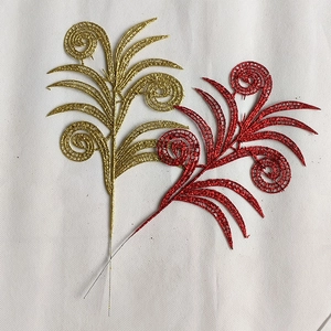 Detail of red and gold glittered hollow leaves with wire stems for Christmas tree decoration