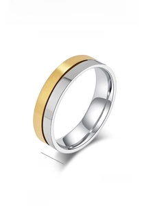Detailed macro view of 5.5mm wide titanium steel ring with gold and silver finish