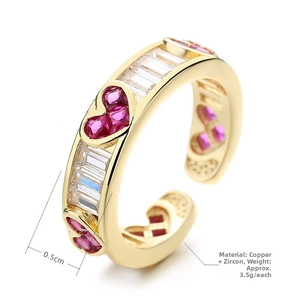 Detail view of gold heart ring showing 0.5cm width with red and white zircons