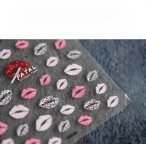 Detail of 5D nail art stickers featuring leopard print and red lips with text