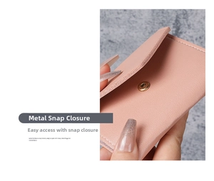 Detail view of pink faux leather wallet showing smooth metal snap button closure