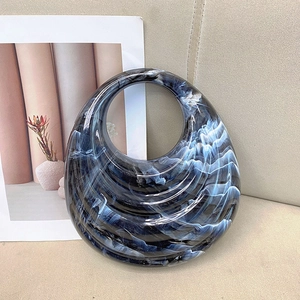 Minimalist acrylic handbag with blue marble texture in a creative crescent shape