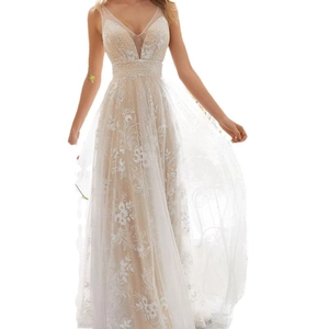 Detail of elegant V-neck sleeveless lace wedding dress with intricate floral embroidery