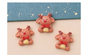Macro view of three resin Christmas reindeer charms for DIY hair accessories and crafts