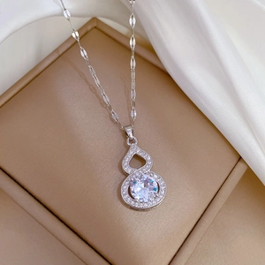 Macro shot of silver gourd pendant with inlaid zircon on a jewelry gift box