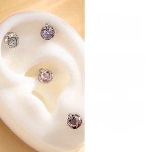Detail view of heart-shaped zircon earrings set in white, purple, pink and deep red colors