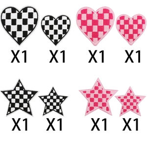 Detail of embroidered checkerboard patches in heart and star shapes for bag decoration