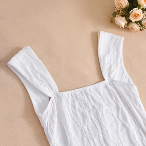 Detailed view of white knitted square neck tank dress with textured rope-braid pattern