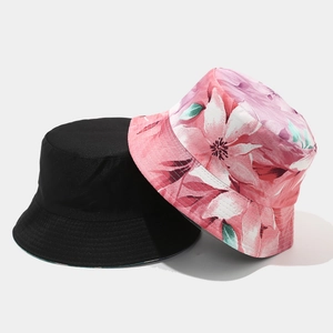 Detail of reversible bucket hat showing black fabric and pink floral pattern texture