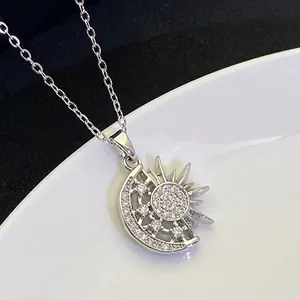 Macro detail of sun and moon pendant with shimmering zircons on silver stainless steel