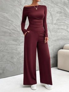 Detail view of burgundy off-shoulder long sleeve top and high waist wide leg pants set