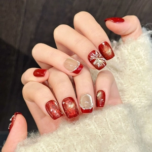 Sparkling red and gold festive press-on nails with firework patterns and pearls
