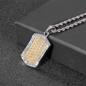 Detail of two-tone hip hop pendant with gold weave and pavé crystals on a rope chain
