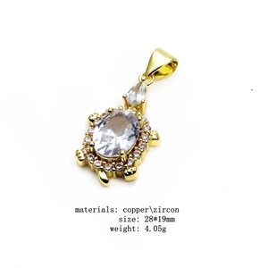 Detailed view of a gold-plated copper turtle pendant with sparkling zircon inlay
