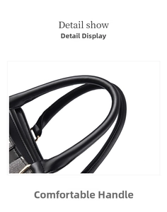 Close-up of dual round black leather handles with gold metal rings and stitching details