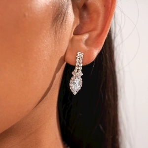 Close-up of elegant silver drop earrings with marquise-cut crystals on model