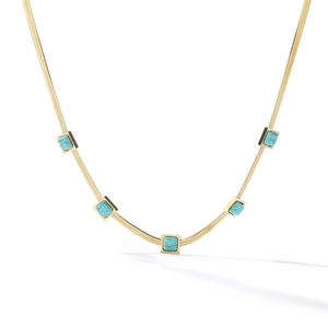 Detail of a gold snake chain necklace featuring five square turquoise stone pendants