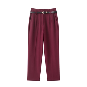High-waisted wine red straight-leg trousers with a black belt on white background