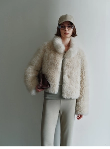 Detail of premium cream faux fox fur vest with plush texture and stand collar design