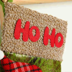 Christmas stocking decorations in red and green featuring Ho Ho felt lettering and knit texture