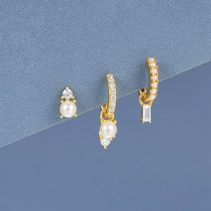 Detail of S925 silver gold-plated hoop earrings with pearls and crystal star charms