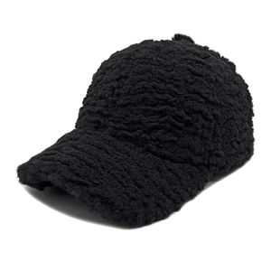 Close-up of black plush lamb wool baseball cap texture and six-panel crown design