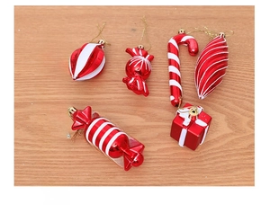 Macro shot of red and white Christmas ornaments including candy canes and gift boxes